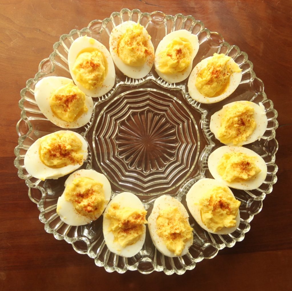 Birdseye view of Deviled Eggs on Crystal Plate with Brown background